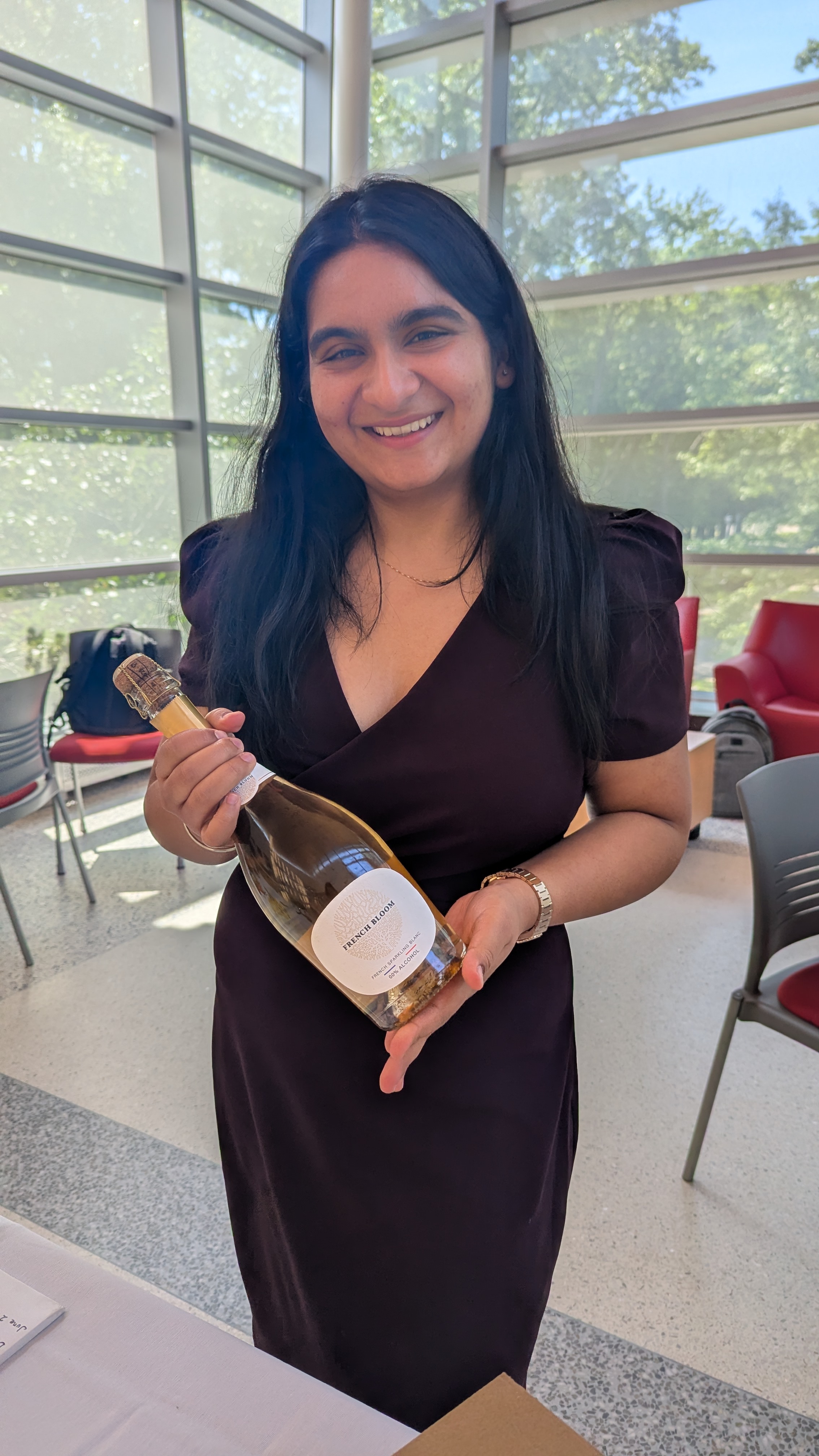 Prerna standing with champagne